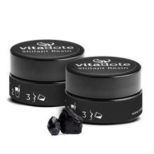 Load image into Gallery viewer, Two black containers of vitadote Shilajit Resin with some resin on a white background